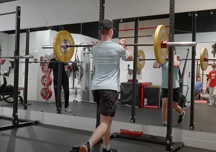 Youth Personal Training Client at BPM Fitness Centre in Victoria, BC doing a barbell lunge