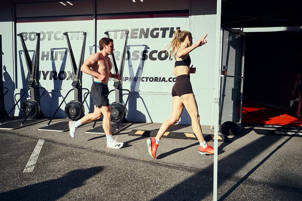 Two HYROX athletes running outside BPM