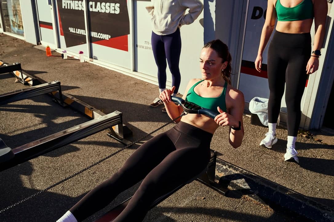 Girl on a Concept2 rower in a HYROX race