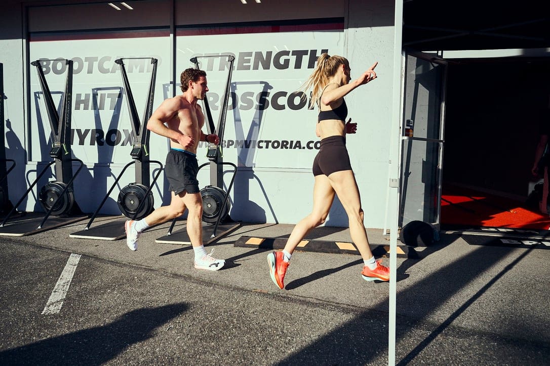 Two HYROX athletes running outside BPM