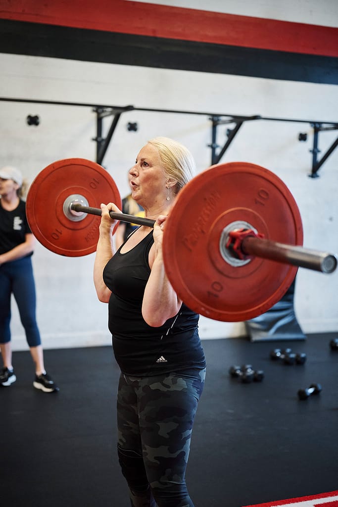 woman performing a barbell press at BPM Fitness Centre