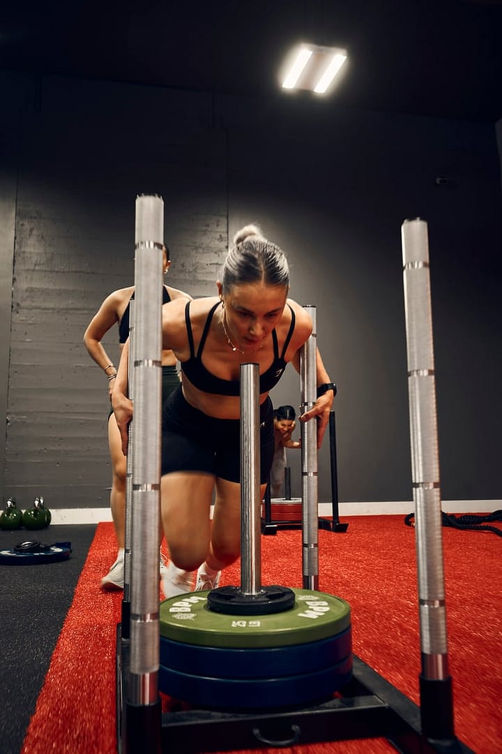 HYROX girl pushing a sled in BPM Fitness Centre
