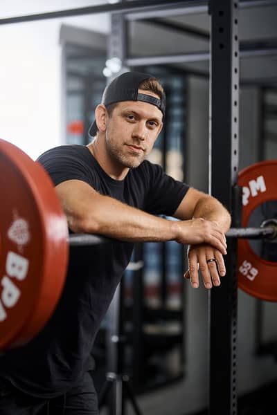 Certified personal trainer at BPM Fitness Centre guiding a client through strength training